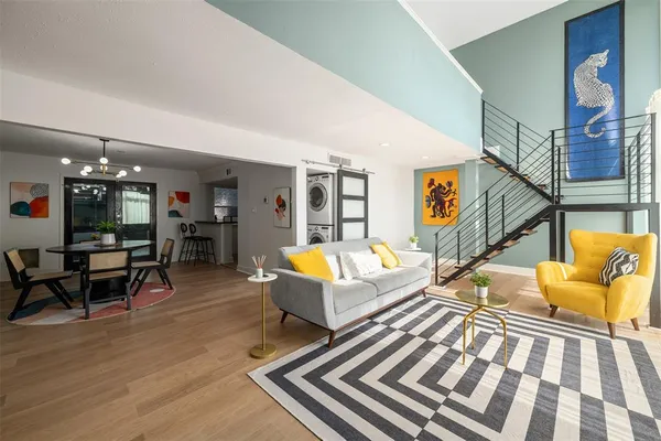 a living room with furniture fireplace and wooden floor