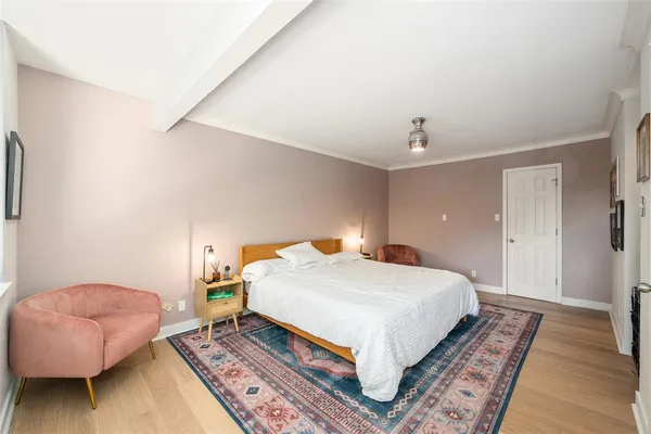 a bedroom with a bed and a couch