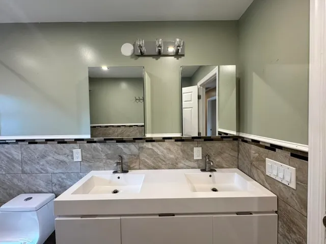 a bathroom with a sink and a mirror