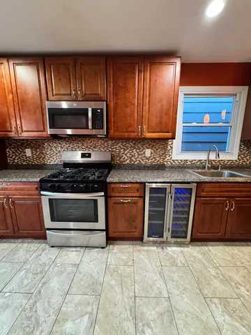 a kitchen with stainless steel appliances granite countertop a sink counter space cabinets and a counter top space