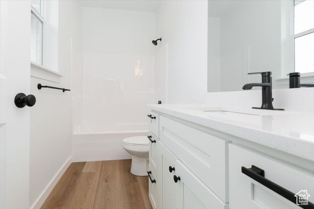 195 West 300 North Logan, UT 84321 - Photo 14 of 20 Full bathroom featuring vanity, light wood-style floors, and washtub / shower combination