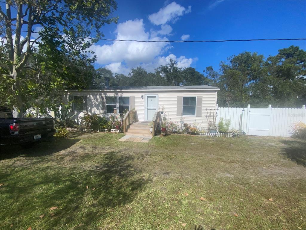 3125 Walk In Water Road Lake Wales, FL 33898 - Photo 1 of 1 a view of a house with backyard and garden