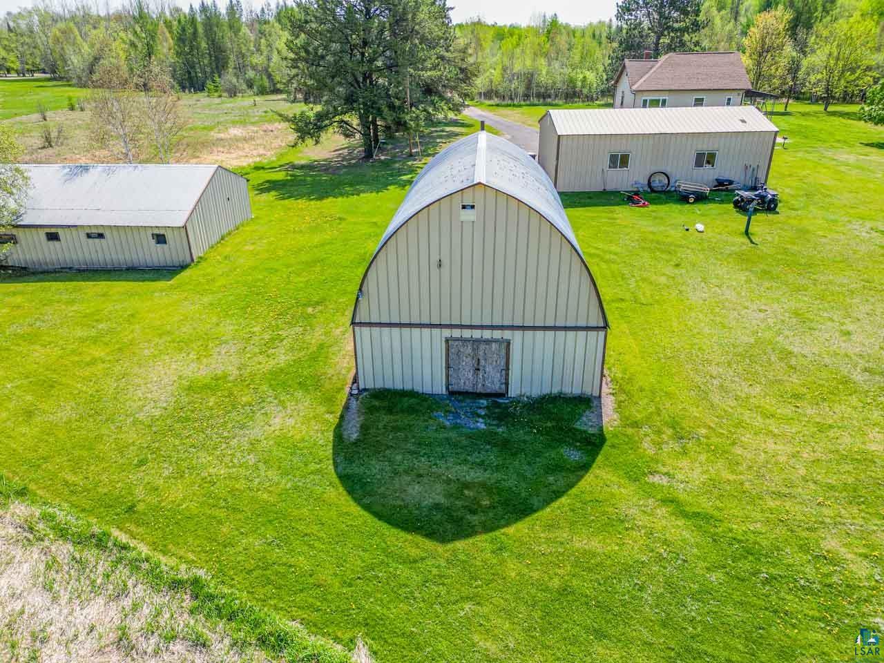 2581 O'Rourke Road Hibbing, MN 55746 - Photo 48 of 61 Quonset hut-style building with a light-colored metal exterior and double wooden doors