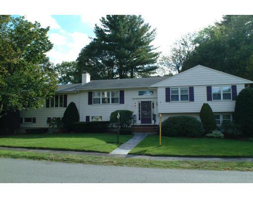 153 Meadowbrook Road Needham, MA 02492 - Photo 1 of 9 a front view of a house with a yard and trees