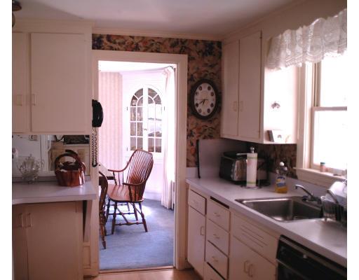 153 Meadowbrook Road Needham, MA 02492 - Photo 4 of 9 a kitchen with cabinets and chairs