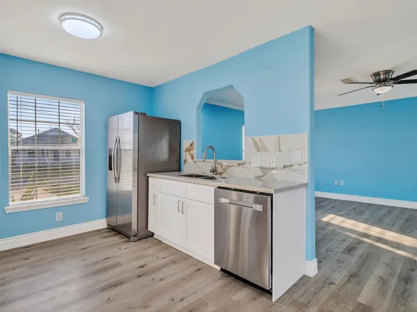 a kitchen with stainless steel appliances kitchen island granite countertop a refrigerator a sink and a stove