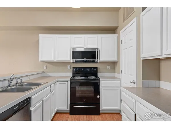 a kitchen with a sink stove and microwave