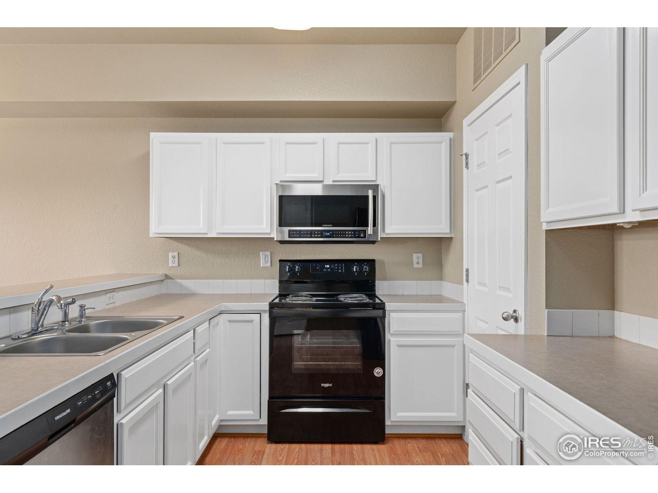6925 19th Street, Unit 15 Greeley, CO 80634 - Photo 12 of 32 a kitchen with a sink stove and microwave