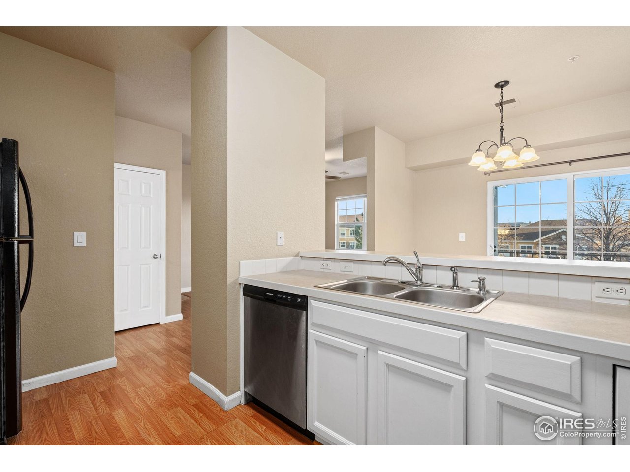 6925 19th Street, Unit 15 Greeley, CO 80634 - Photo 14 of 32 a kitchen with a sink and a mirror
