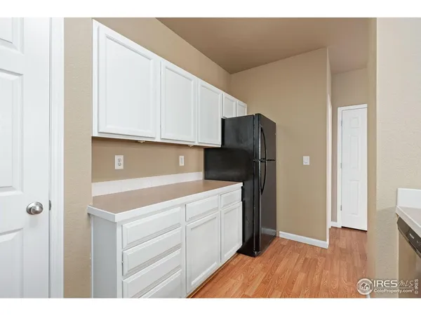 a kitchen with cabinets and stainless steel appliances