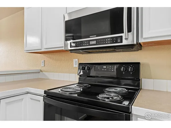 a kitchen with a stove and a microwave