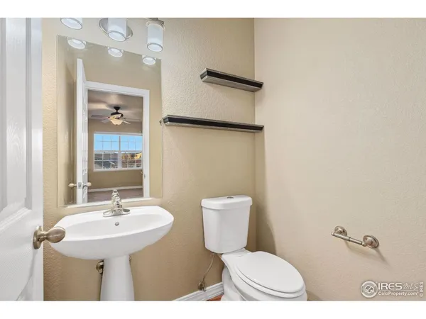 a bathroom with a sink a toilet and mirror