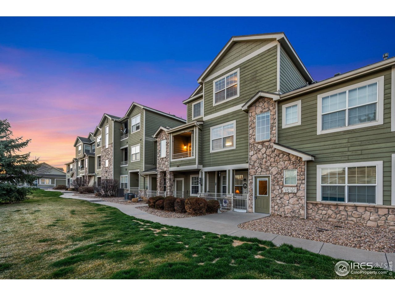 6925 19th Street, Unit 15 Greeley, CO 80634 - Photo 3 of 32 a front view of a house with a yard