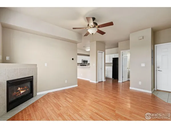 a view of an empty room with a fireplace and a window