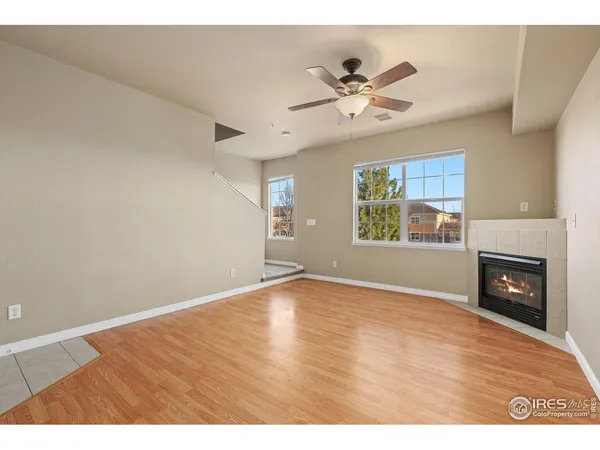 a view of an empty room with a window and fireplace