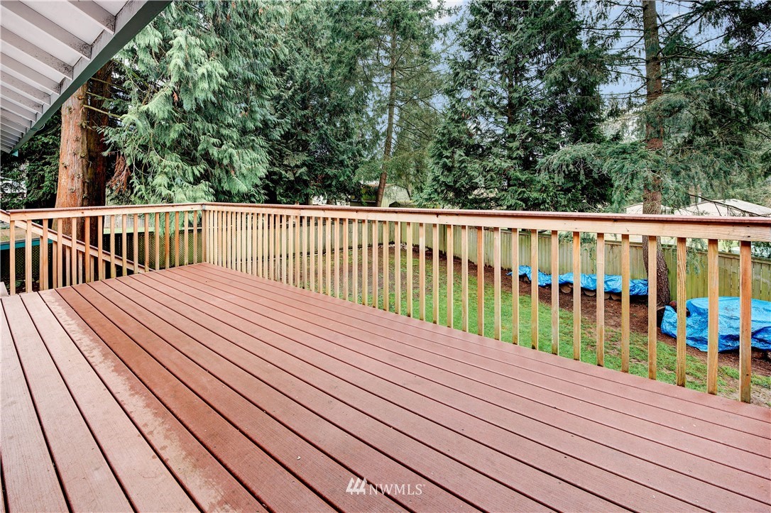 24012 23rd Avenue West Bothell, WA 98021 - Photo 22 of 28 a balcony with wooden floor and trees in the back