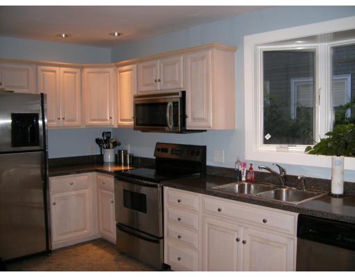 9 Hillside Road Newton, MA 02461 - Photo 3 of 9 a kitchen with white cabinets and black appliances