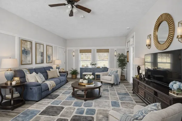 a living room with furniture and a wooden floor