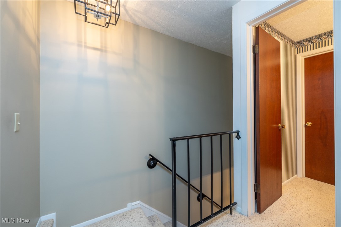 6474 State Road, Unit I10 Parma, OH 44134 - Photo 26 of 31 Stairway with a textured ceiling and speckled floor