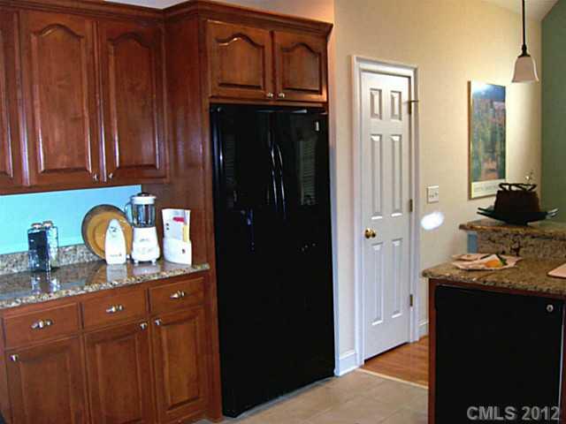 581 Mason Dickson Road York, SC 29745 - Photo 3 of 16 a kitchen with granite countertop cabinets and refrigerator
