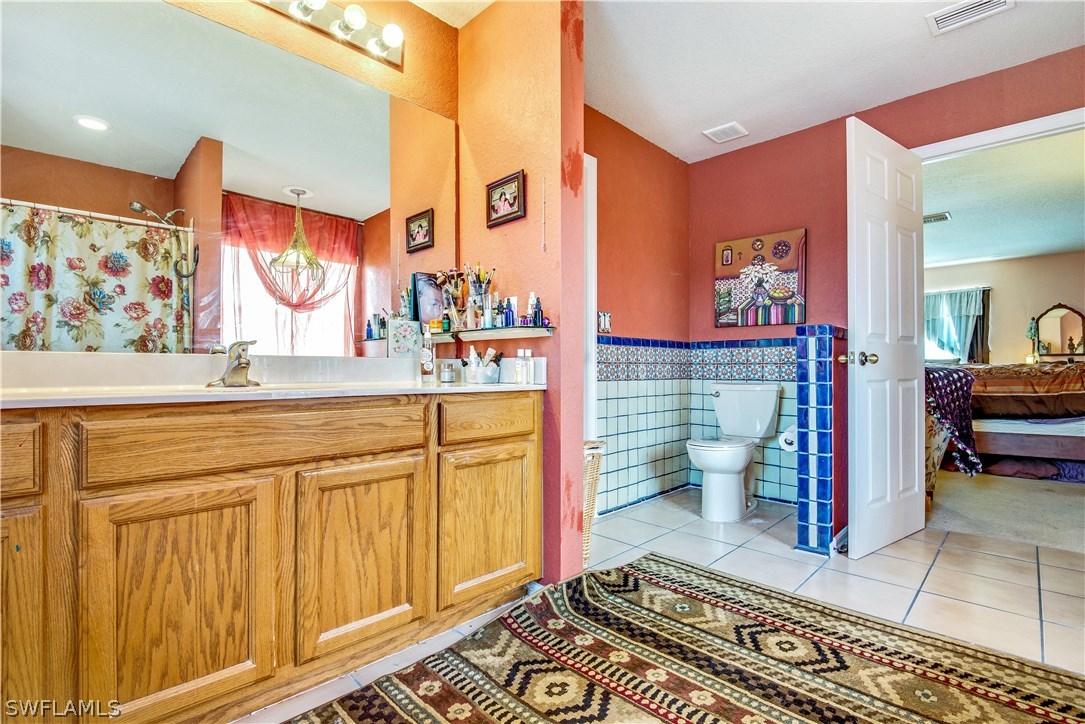 421 Jourferie Road Lehigh Acres, FL 33974 - Photo 16 of 25 a bathroom with a sink and a mirror