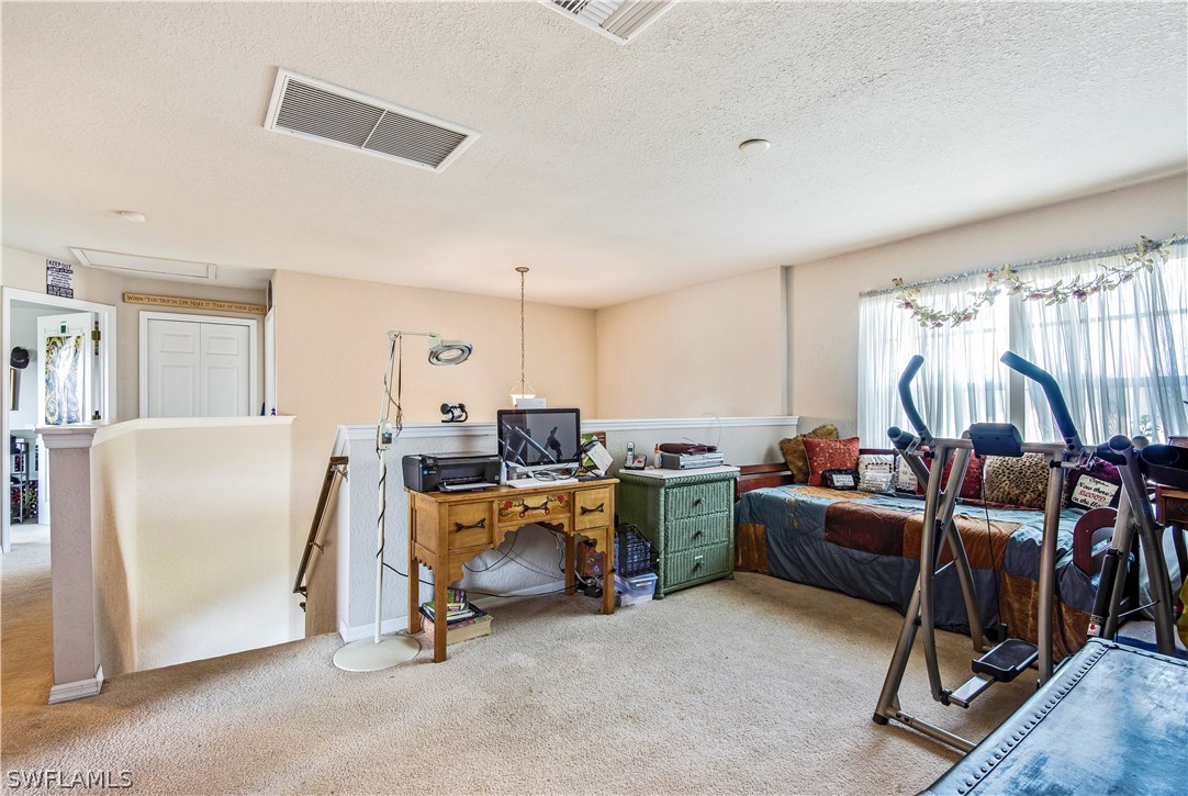 421 Jourferie Road Lehigh Acres, FL 33974 - Photo 17 of 25 a view of a livingroom with workspace and a window