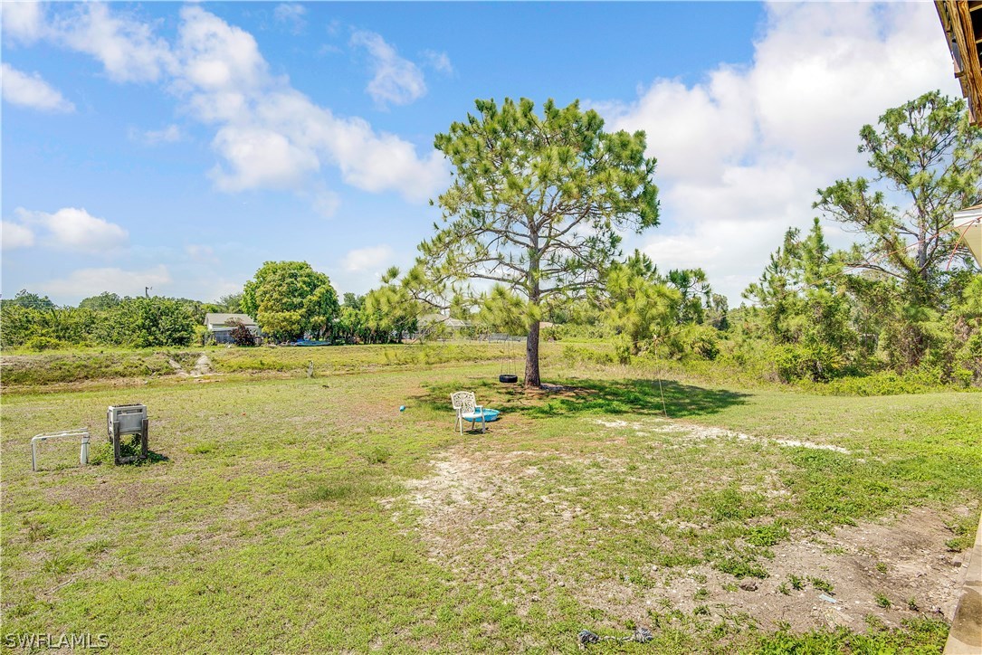 421 Jourferie Road Lehigh Acres, FL 33974 - Photo 24 of 25 a lake view with houses in back