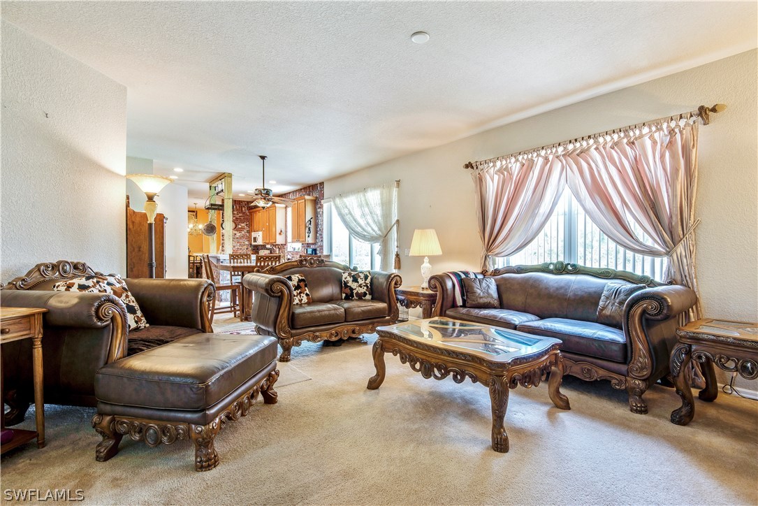 421 Jourferie Road Lehigh Acres, FL 33974 - Photo 4 of 25 a living room with furniture and a large window