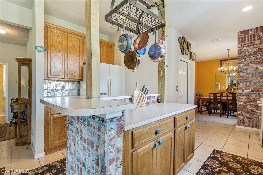 421 Jourferie Road Lehigh Acres, FL 33974 - Photo 8 of 25 a bathroom with a granite countertop sink a mirror and shower