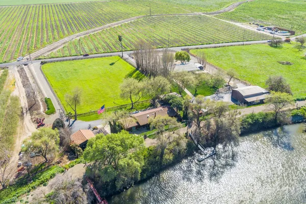 a kitchen with a table chairs and a living room