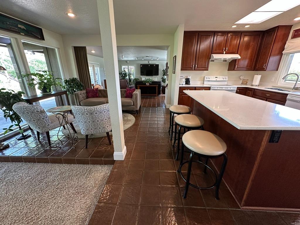 14101 Bethany Road Tracy, CA 95304 - Photo 18 of 68 a kitchen with a table chairs and a living room