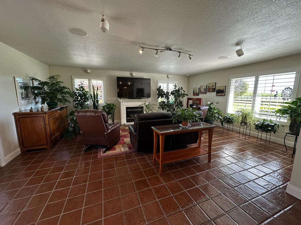 14101 Bethany Road Tracy, CA 95304 - Photo 22 of 68 a living room with furniture a flat screen tv and a dining table