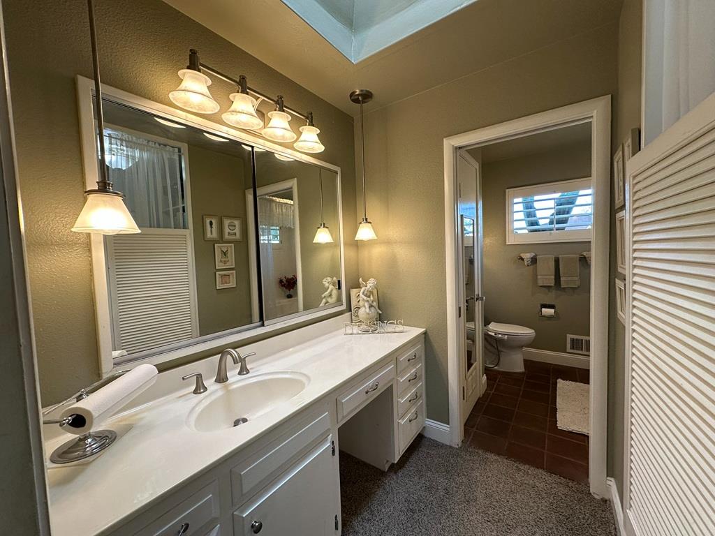 14101 Bethany Road Tracy, CA 95304 - Photo 36 of 68 a bathroom with a double vanity sink and a mirror