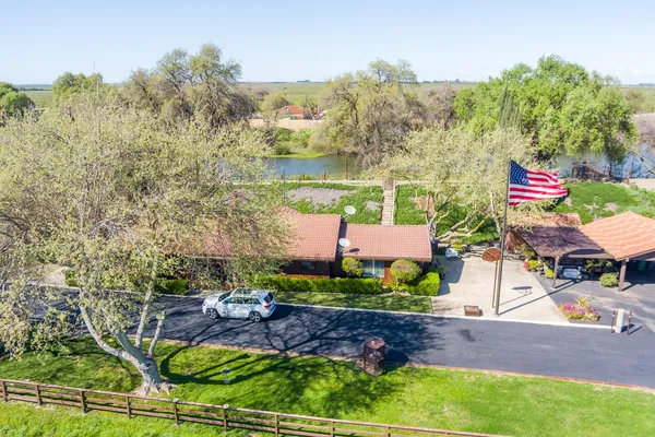 an aerial view of a house with a yard and garden