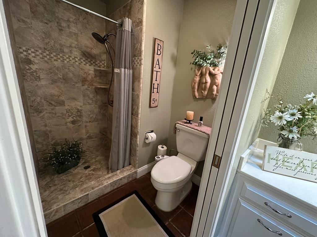 14101 Bethany Road Tracy, CA 95304 - Photo 42 of 68 a bathroom with a granite countertop sink toilet and shower