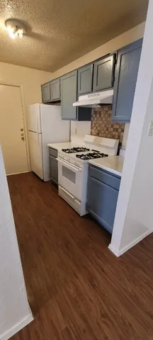 a kitchen with stainless steel appliances granite countertop a stove and a refrigerator