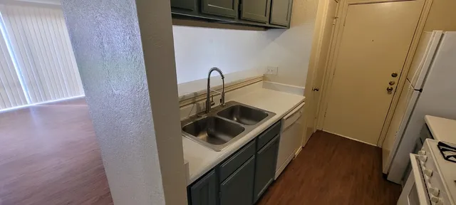 a kitchen with a sink and cabinets