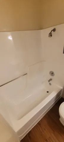 a bathroom with a bathtub and shower