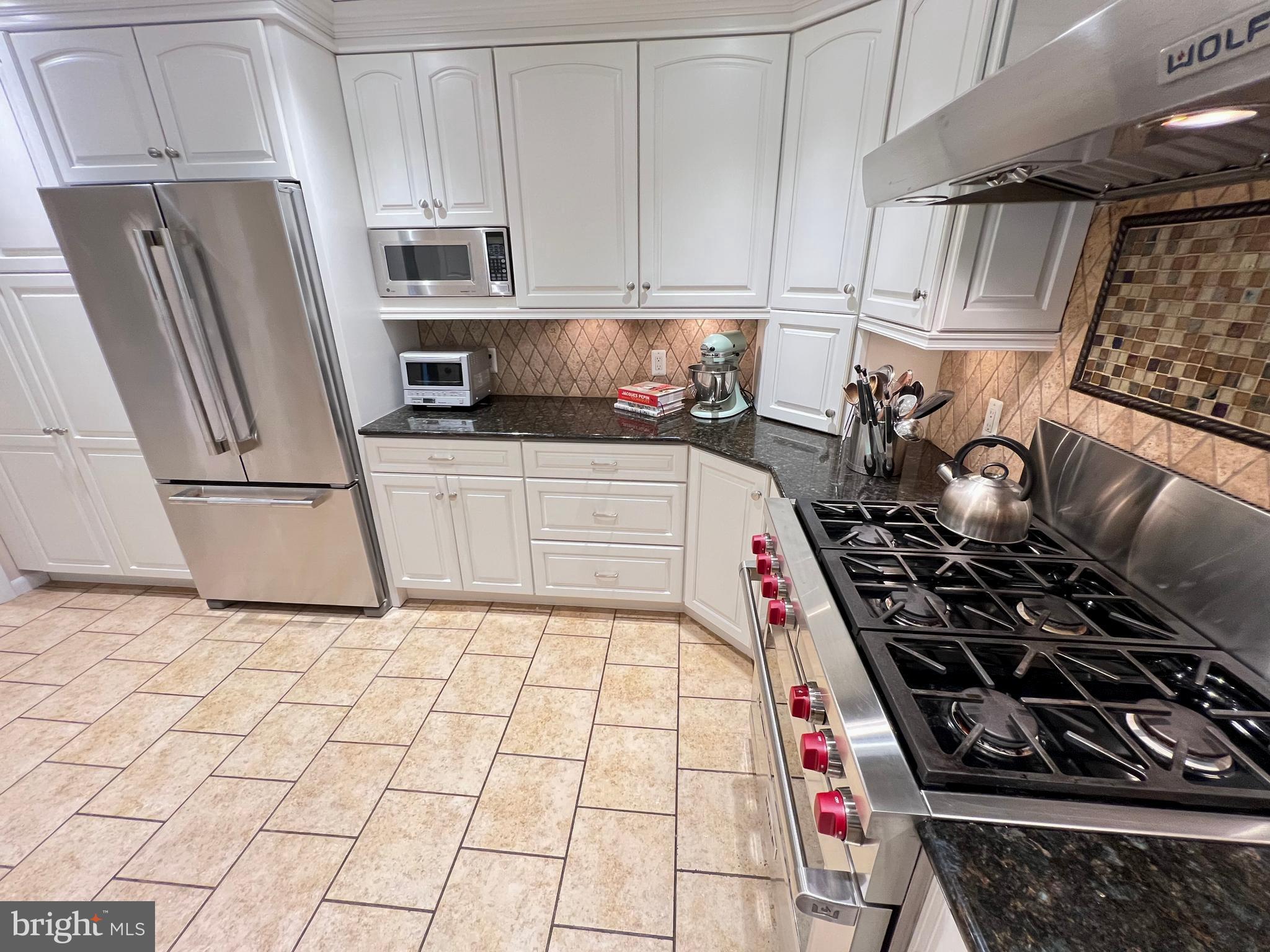1027 Hart Road Baltimore, MD 21286 - Photo 12 of 94 a kitchen with stainless steel appliances granite countertop a stove and a refrigerator