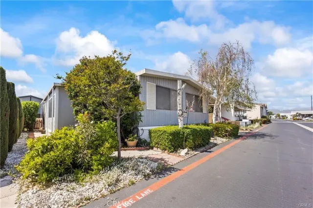 a front view of a house with a yard and outdoor seating