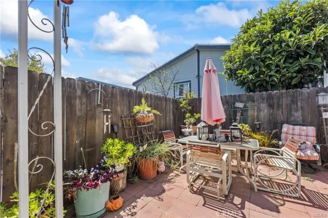 a view of a chairs and table in a backyard