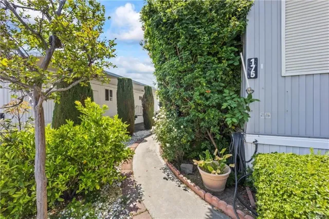 a front view of a house with a yard and potted plants