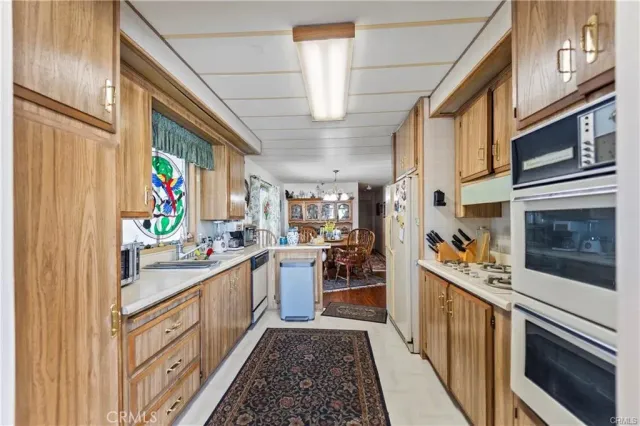a kitchen with stainless steel appliances granite countertop a stove and cabinets