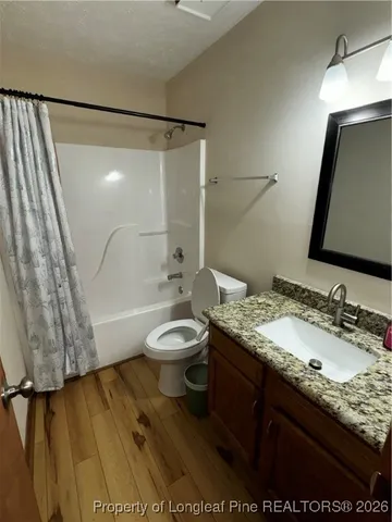 a view of a livingroom with a ceiling fan and window