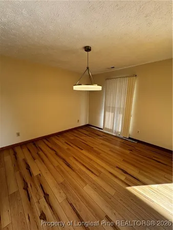 a view of a room with wooden floor and fan