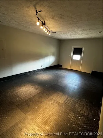 a view of room and hall with wooden floor