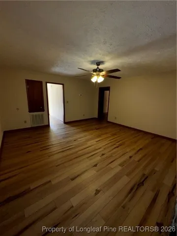 a view of an empty room and window and fire place