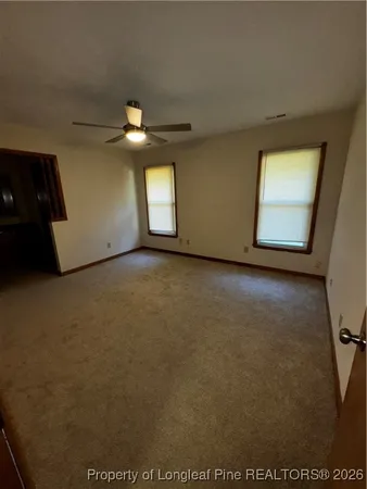 a view of a livingroom with a ceiling fan and a ceiling fan