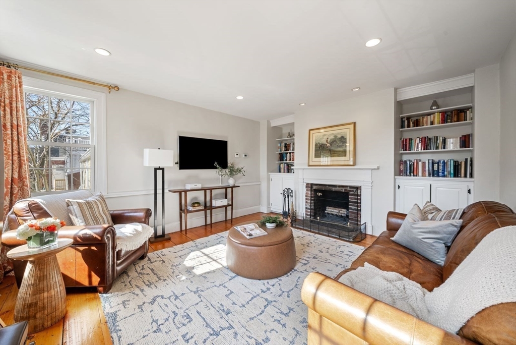 10 Summer Street, Unit 1 Boston, MA 02129 - Photo 13 of 37 a living room with furniture a fireplace and a flat screen tv