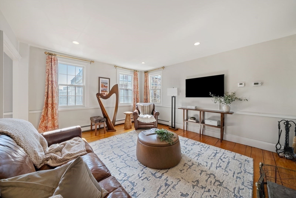 10 Summer Street, Unit 1 Boston, MA 02129 - Photo 15 of 37 a living room with furniture a flat screen tv and a window